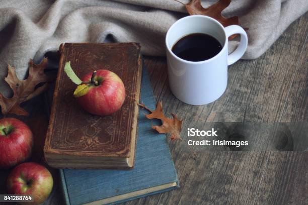 Autumn Still Life With Apples Warm Blanket Books White Coffee Cup And Leaves Over Rustic Wood Background Stock Photo - Download Image Now