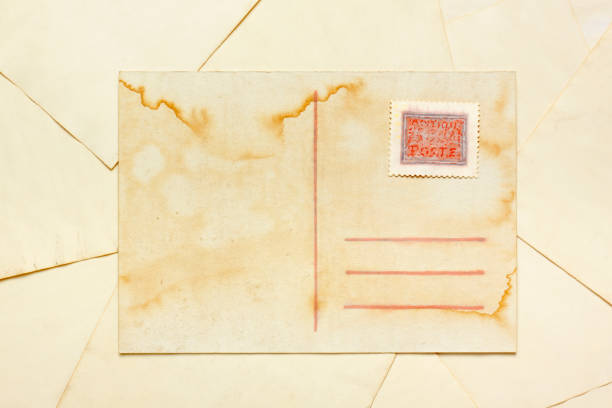 Aged empty postcard with painted abstract postage stamp Aged empty postcard with painted abstract postage stamp over aged paper sheets carte antique stock pictures, royalty-free photos & images