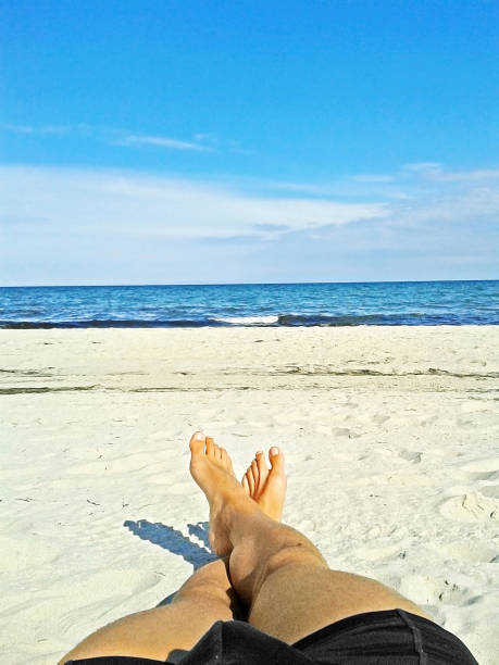 istock Enjoying the beach - male feet, sand, ocean 841293002