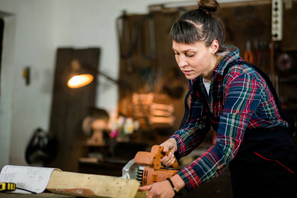 istock Young Woman Measuring Wooden Plank 841294622