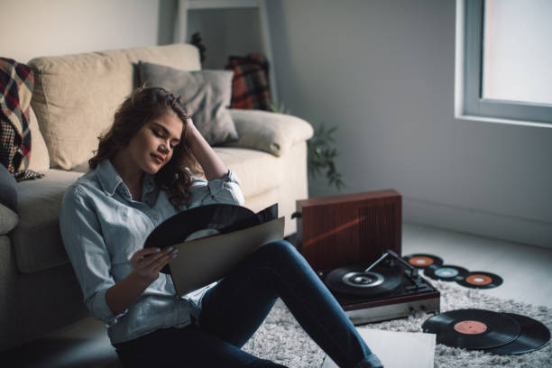 istock Young woman enjoing music from gramophone 841295046