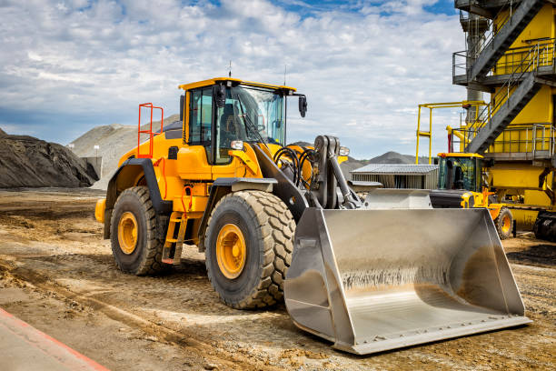 istock Earth mover in front of cement plant 841307294