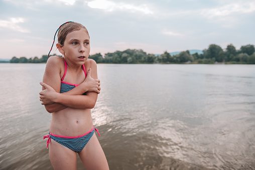 Girl shivering after a swim in the freezing cold river