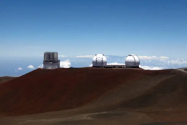 Three observatories on horizon at peak of extinct volcano