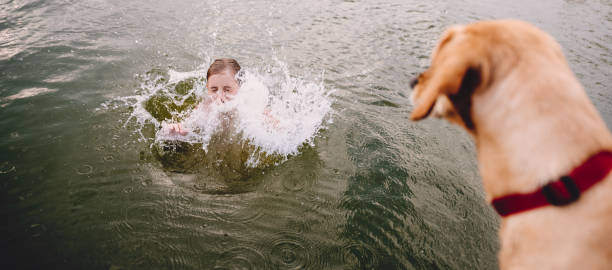 istock Girl jumping into water 841308830