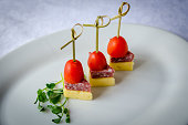 Close up of skewers with cherry tomato, cheese and salami