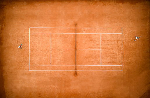 Empty tennis stadium with tennis racket and tennis balls.