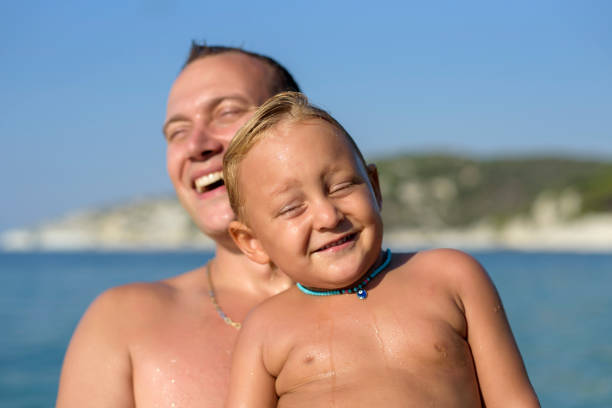 Happy children playing in the river.  Summer holidays on the beach.