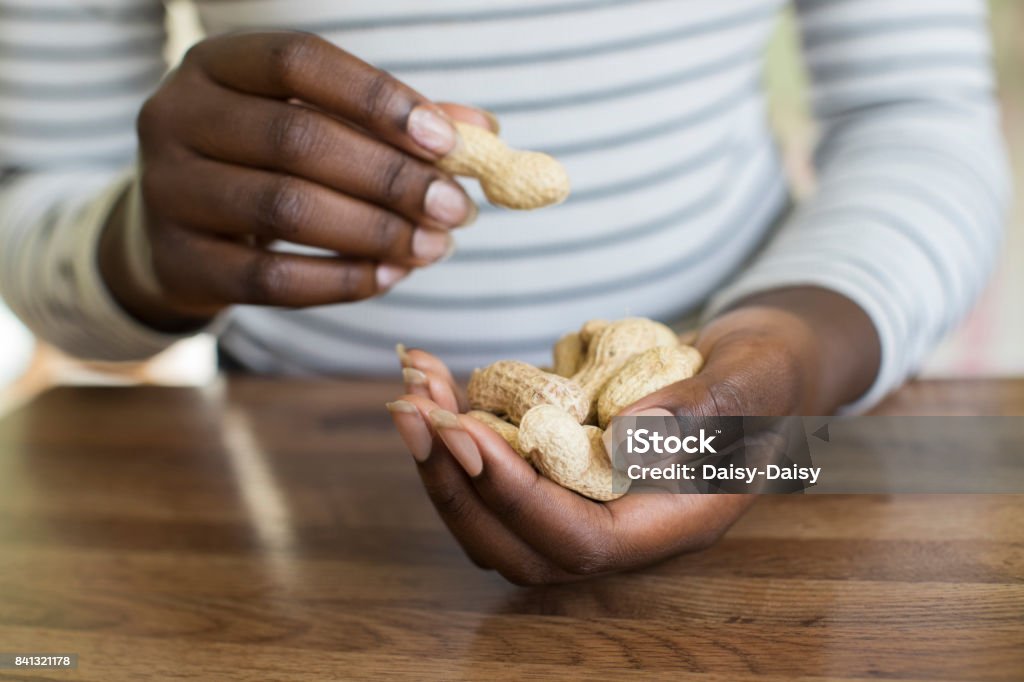 Close Up Of Teenage Girl With Handful Of Peanuts In Shells Peanut - Food Stock Photo