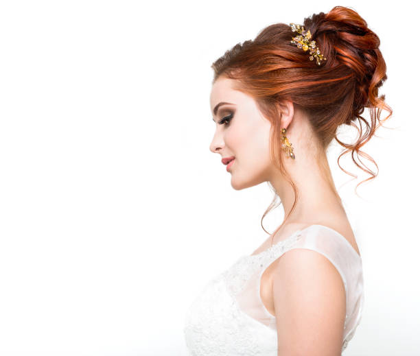 Young pretty caucasian bride in wedding dress at studio
