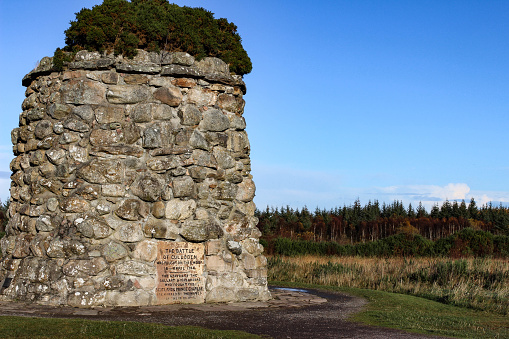 Giant cairn or grave marker at Culloden Moor, Scotland during a crisp autumn day.