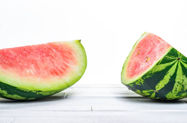 istock Two pieces of fresh watermelon on white table 841333358