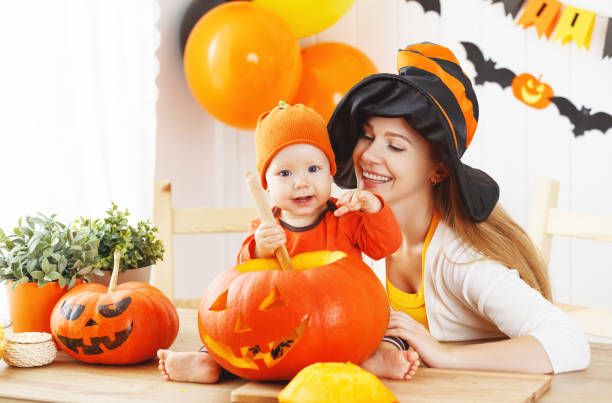 istock mother and baby cut  pumpkin for Halloween in kitchen 841336220