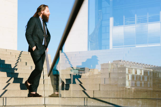 istock mature businessman with long hair and beard makes his way 841337954