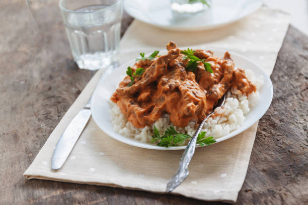 istock Dish rice with beef stroganoff on a white plate 841345174