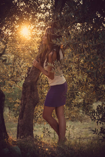 istock beautiful women olive tree in tuscany 841345552