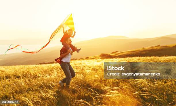 Happy Family Father And Child Daughter Run With Kite On Meadow Stock Photo - Download Image Now