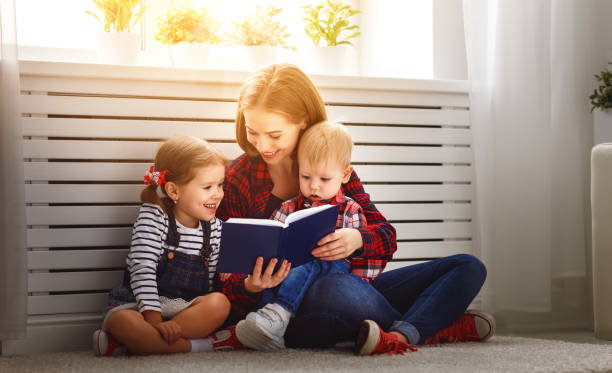 istock Mother reads book to children 841348376