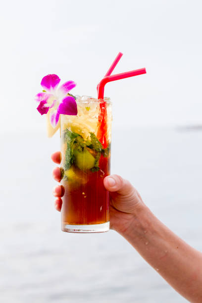 istock Refreshing drink with lime, mint and pineapple on a tropical beach, close up. Mojito cocktail 841350992