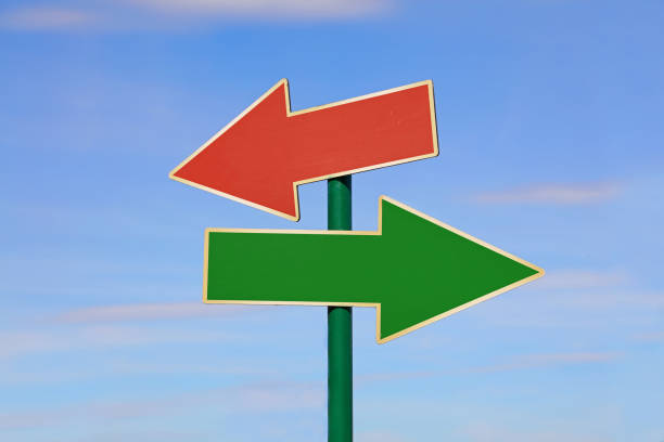 istock Road sign with two different arrows over blue sky 841351222