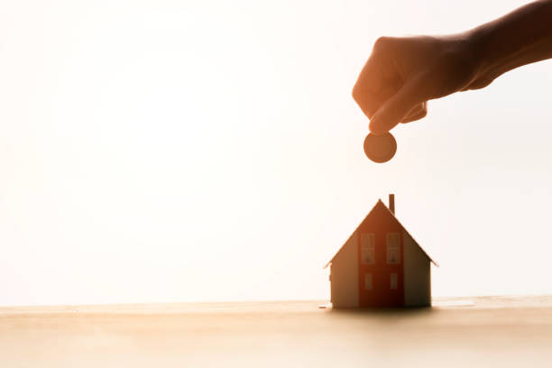 istock Real Estate Agent with house model and saving concepts (Backlights Concepts) 841353988