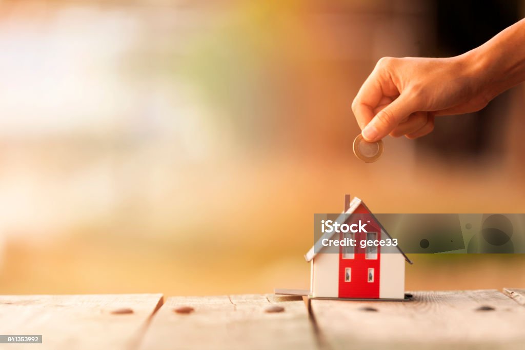 Real Estate Agent with house model and saving concepts House Stock Photo