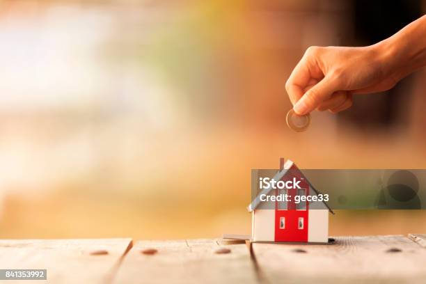 Real Estate Agent With House Model And Saving Concepts Stock Photo - Download Image Now