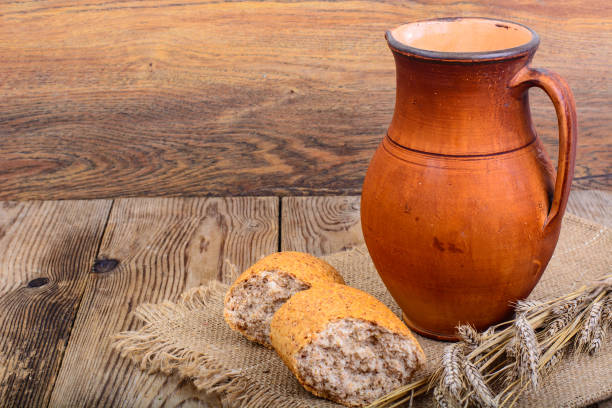 istock Healthy rustic breakfast. Milk in jug and bread on wooden table 841361648