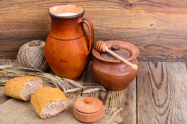 istock Healthy rustic breakfast. Milk in jug and bread on wooden table 841363960
