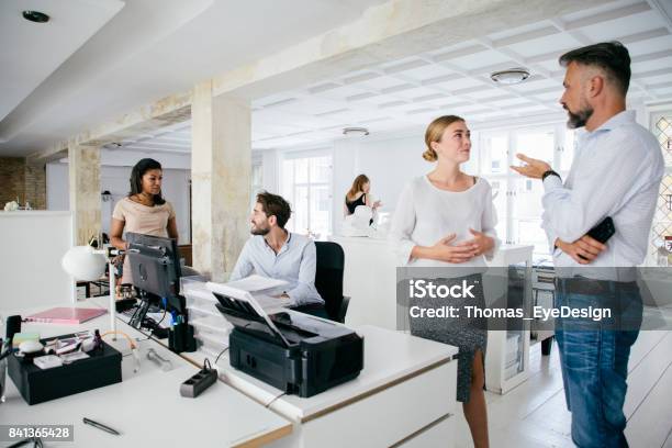 Young Professionals Working Together In Modern Office Space Stock Photo - Download Image Now