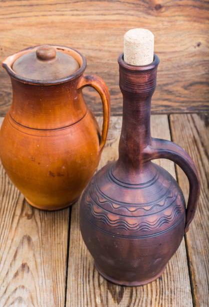 istock Vintage clay pitchers on wooden background 841365706
