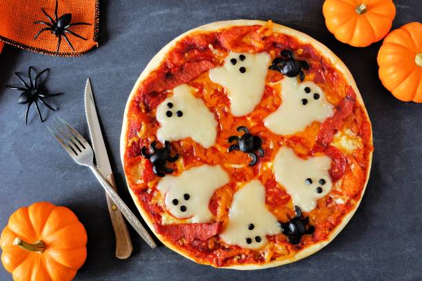 istock Halloween pizza, above scene with decor on black background 841372894