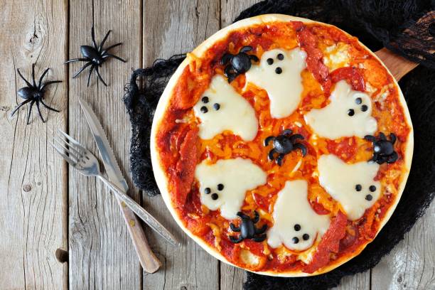istock Halloween pizza above scene with decor on rustic wood 841372958