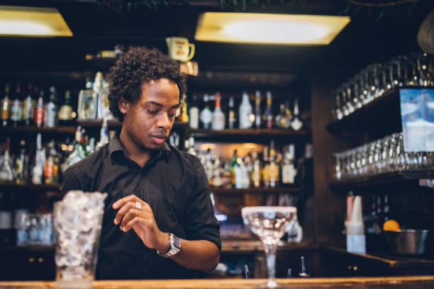 Barman is making cocktail at night club