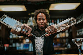 Young barista making coctails