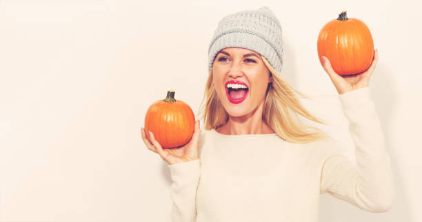 istock Young woman holding pumpkins 841383104