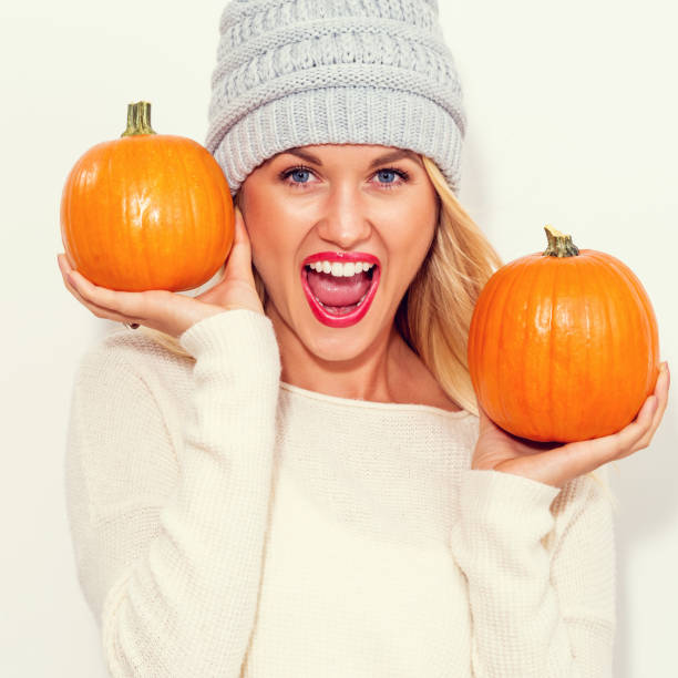 istock Young woman holding pumpkins 841383154
