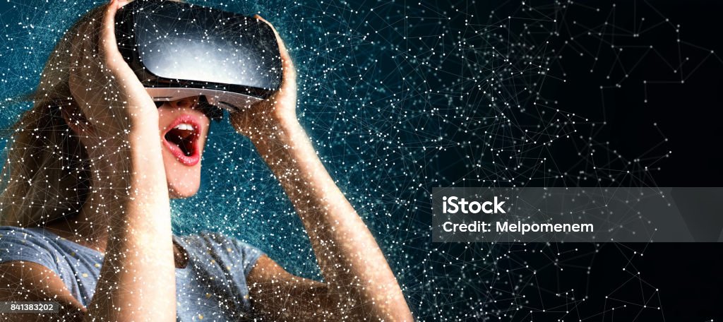Young woman using virtual reality headset Happy young woman using a virtual reality headset Virtual Reality Stock Photo
