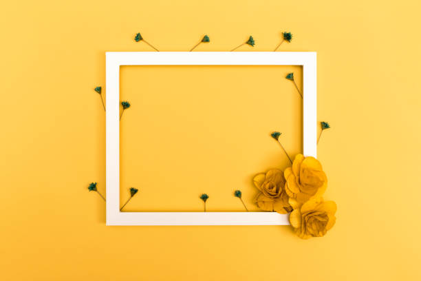 istock Picture frame with flowers on yellow 841383570