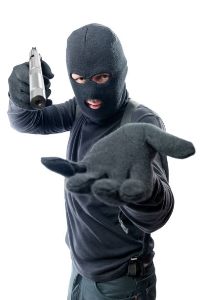 istock Armed robber requires money and aims at the camera 841397082