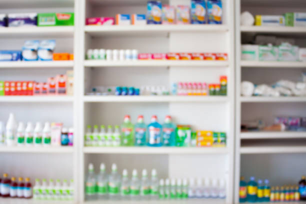 istock pharmacy store with blur medicines arranged on shelves 841397176