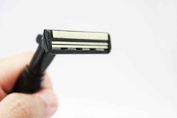 istock Hand with shaving razor isolated on a white background 841397334