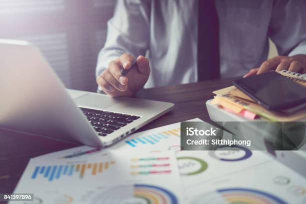 Businessman Hand Working Smart Phone On Wooden Desk In Office In Morning Light The Concept Of Modern Work With Advanced Technology Vintage Effect Stock Photo - Download Image Now