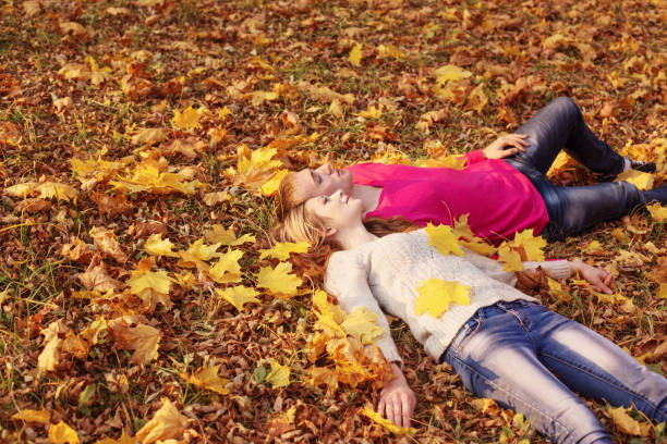 istock romantic couple in the autumn park 841404344