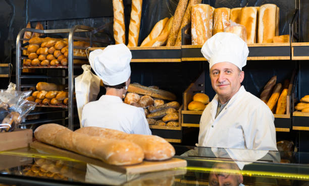 istock attentive bakers with fresh bread in bakery 841405826