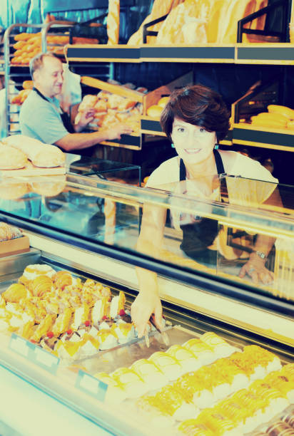 istock mature woman baker with fresh bread in bakery 841405908