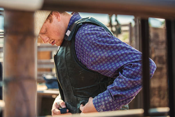 istock strapping on protective vest to ride in the rodeo 841422612