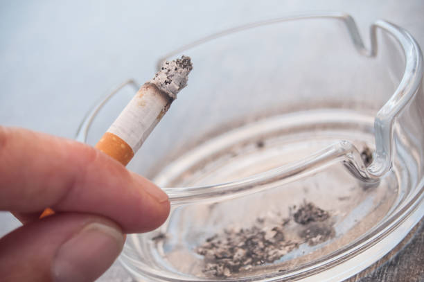 istock hand of man with cigarette and ashtray 841423114