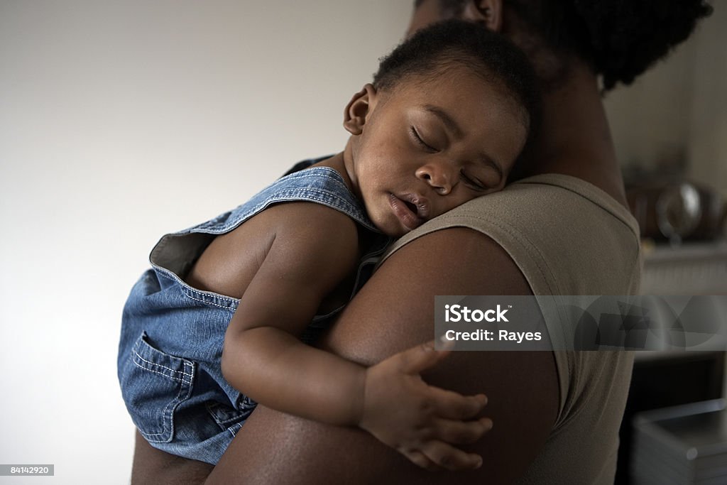 baby asleep on mums shoulder  Baby - Human Age Stock Photo