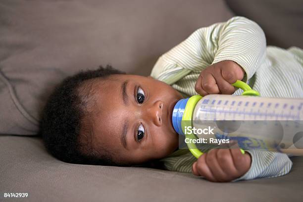 Baby Feeding Himself A Bottle Of Milk Stock Photo - Download Image Now - Baby - Human Age, Baby Bottle, Drinking